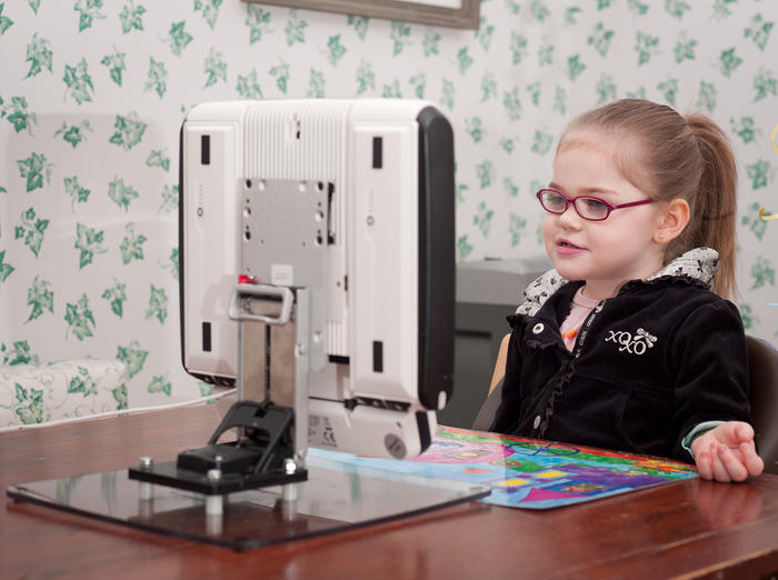 Cata uses a Mount'n Tilter with her Tobii on a table.