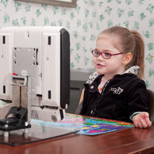 Cata uses a Mount'n Tilter with her Tobii on a table.