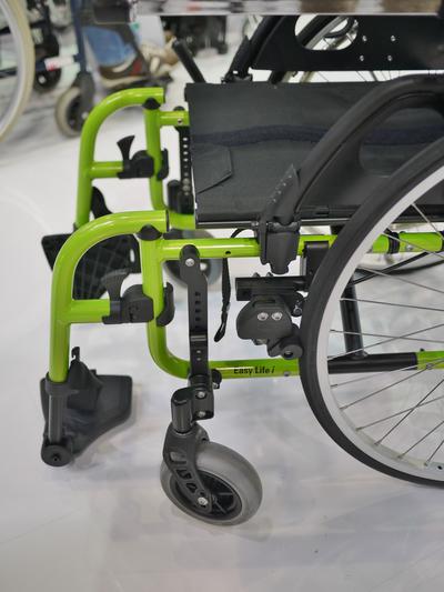 Approach 1: Attach to the Easy Life with an Adapter Plate, using the holes in the plate spanning the two horizontal tubes. Use an L-Angle extension plate to offset the Wheelchair Bracket.