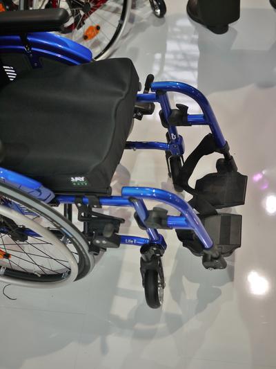 Use a bridge clamp to attach to the frame and use offsets as needed to position the Wheelchair Bracket..
