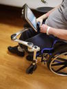 The Solid Wheelchair Bracket is attached to the front of the L-Angle Extension so the brake may be used. This person does not use their footrests.