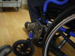 Attach an L-angle extension to offset the Wheelchair bracket forward, away from the brake. Your set-up may differ.