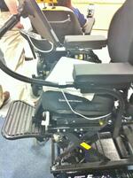 The seat elevates, so attachment should be to the upper seat frame.