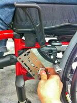 An Adapter Plate 4 or 2 can be used to create the Bridge (AP2 is shown). You will need an Angle Adjust Plate and possibly an L-Angle plate to position the Wheelchair Bracket to avoid the brake handle and footrest.